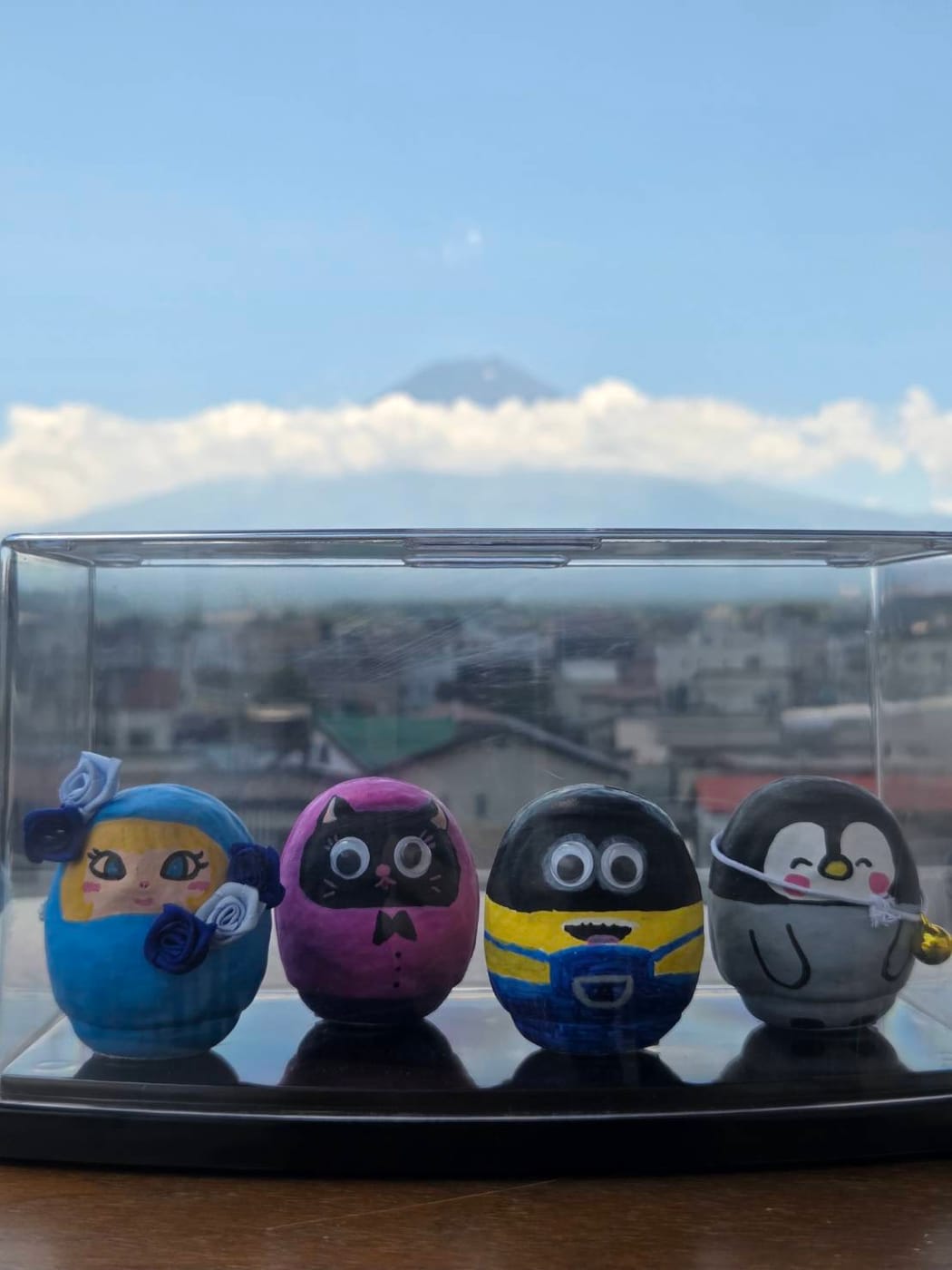 Character daruma displayed with a Mt. Fuji view