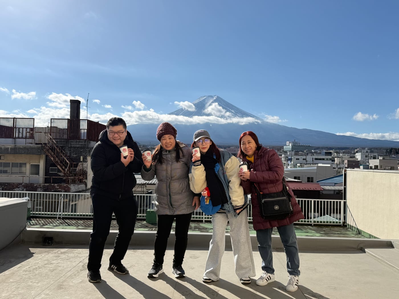 Guests taking rooftop photos with Mt. Fuji