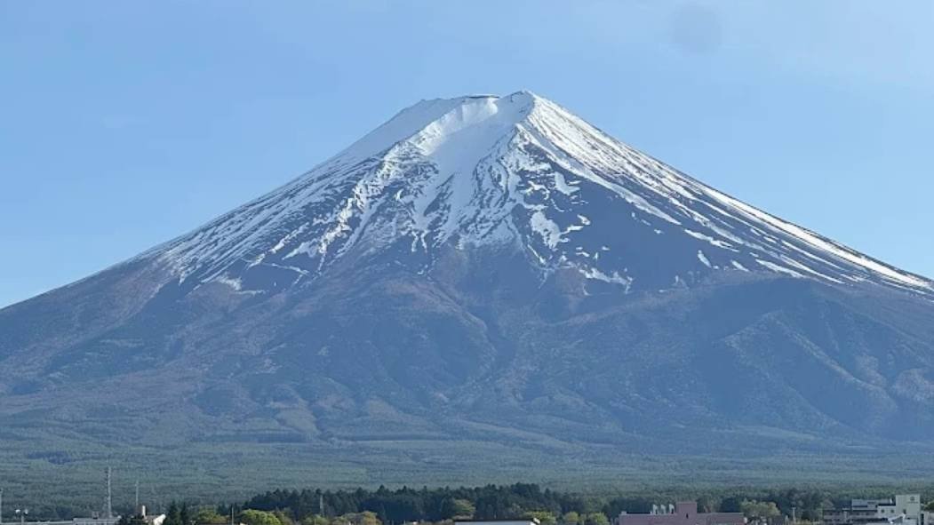 Mt. Fuji with snowcap over Fujiyoshida, viewed from the rooftop matcha café