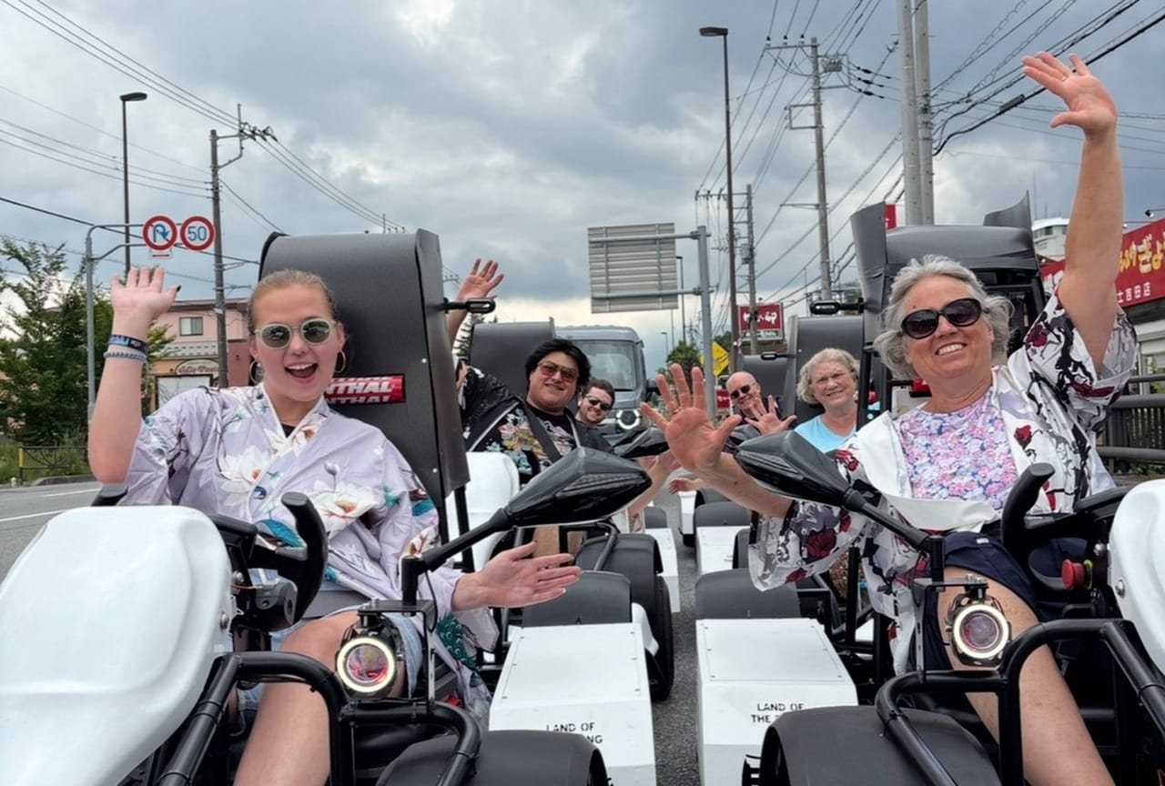 Guests waving on Mt. Fuji electric go-karts