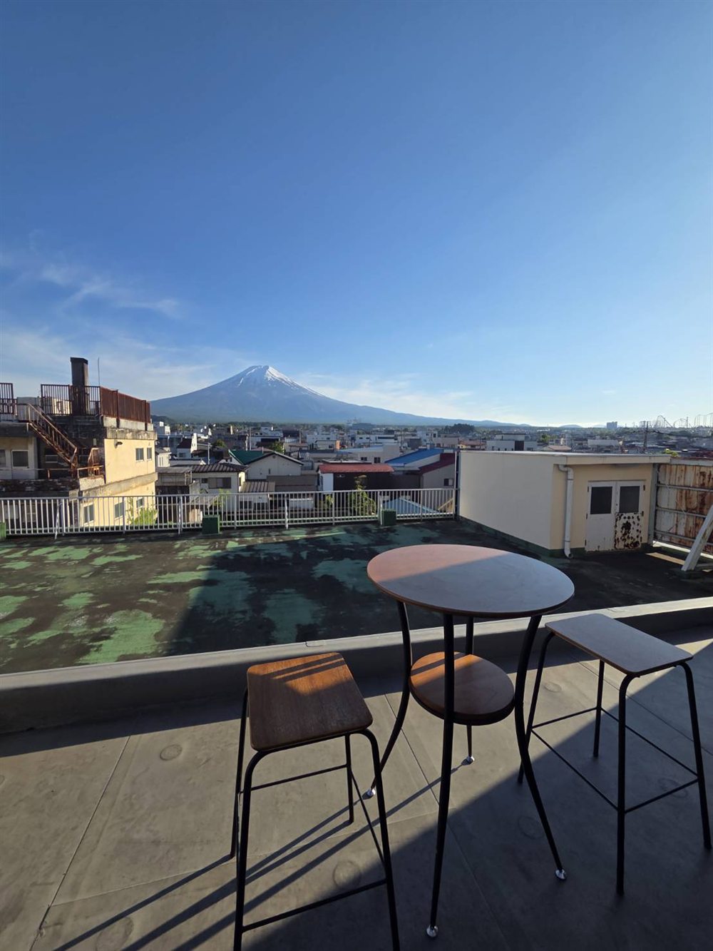 Rooftop café table with Mt. Fuji in golden afternoon light